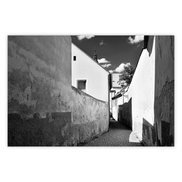 Poster Narrow alley - black and white urban street scene against architectural backdrop