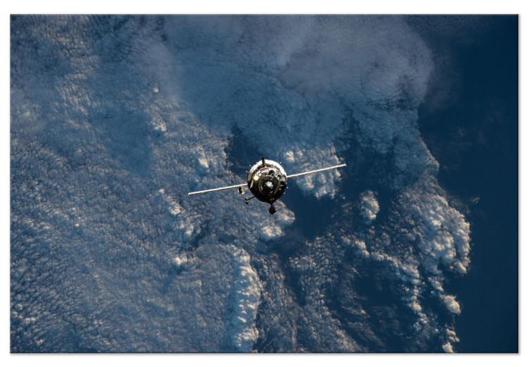 Canvas Print Space vehicle in orbit - photo of a rocket in the clouds