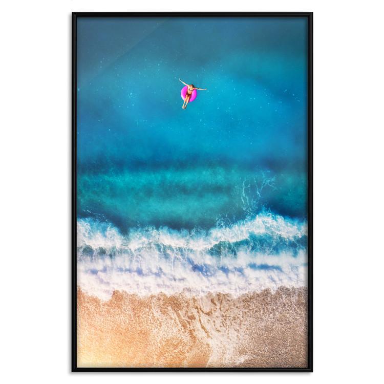 Poster Sea Bathing - woman on float in sand and blue sea background