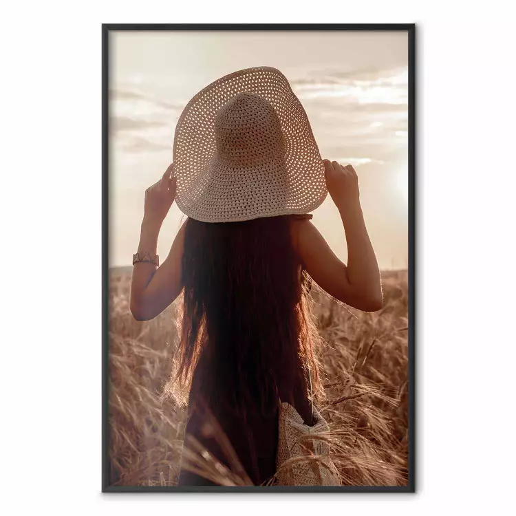 Late Harvest - landscape of a field and a woman against the setting sun