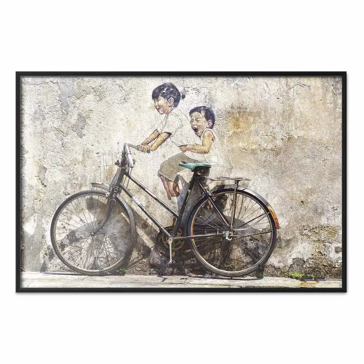 Carefree - retro black bicycle against a wall painted with children