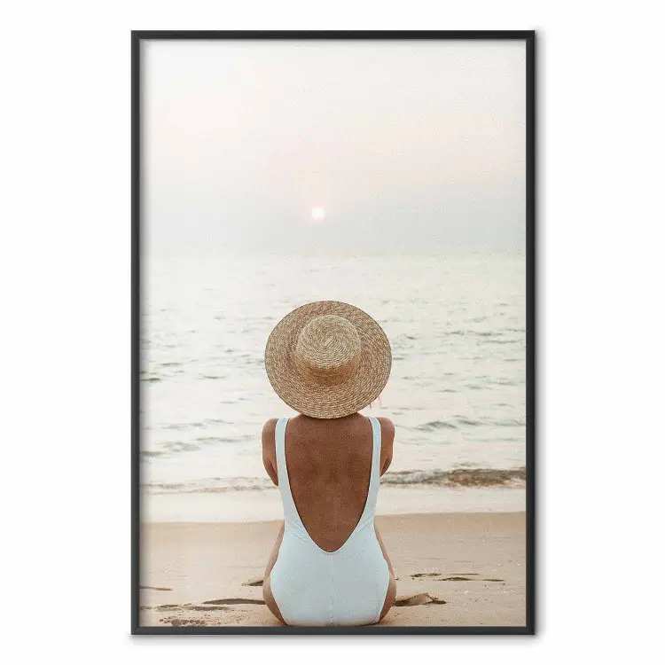 Beach Rest - woman sitting on the sand with sunset in the background