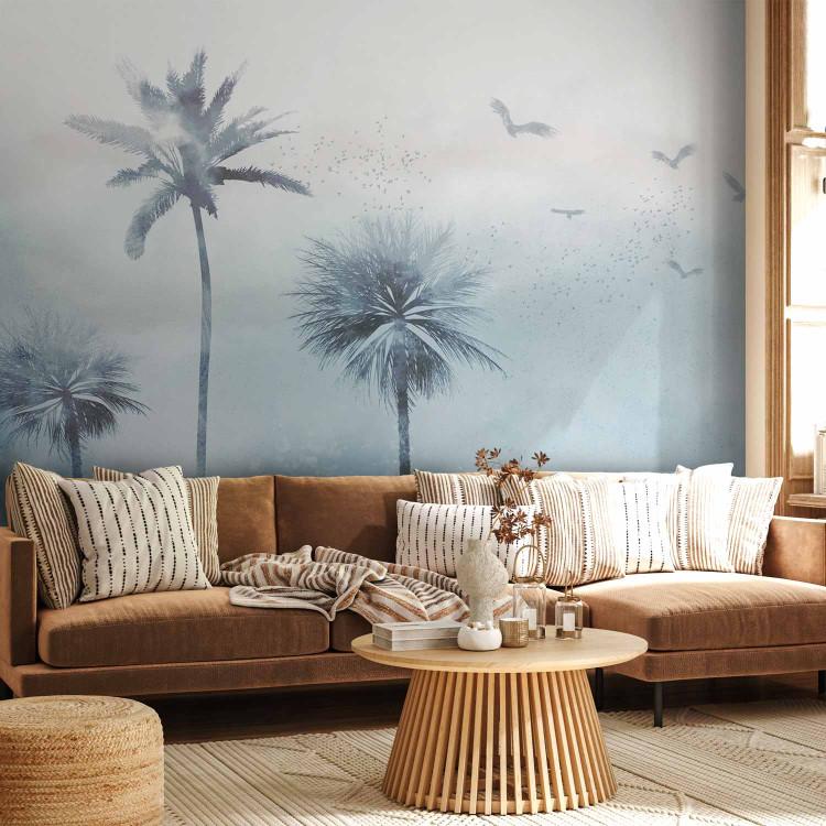 Wall Mural A breeze of tropics - a cloudy landscape depicting palms and birds