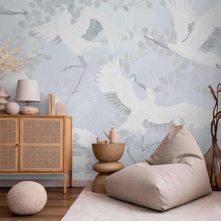 Wall Mural Dancing animals - birds among the leaves on a background in shades of blue
