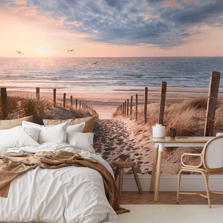 Wall Mural Windblown sand - sunny landscape with beach descent and sea in the background