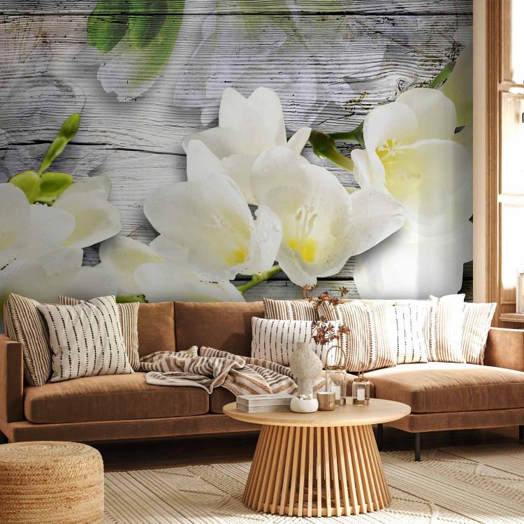 Wall Mural Beauty of Nature - White freesia flower with shadow on a gray wooden background