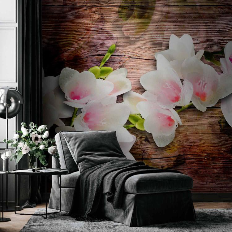 Wall Mural Nature's Elegance - white magnolia flowers on aged wood with reflection