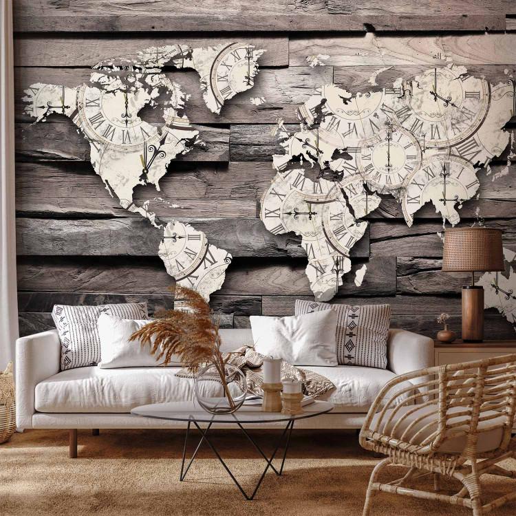 Wall Mural Passing time of the Earth - map of the world with a clock motif on grey wood