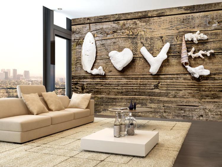 Wall Mural Romantic confession - love inscription with seashells on brown wood