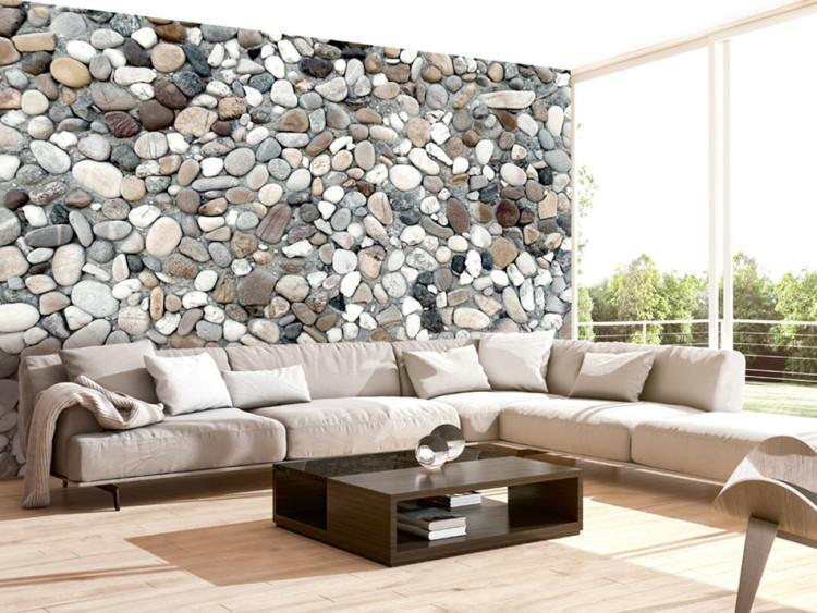 Wall Mural Gray Rocky Beach - Background with Uniform Motif of Various Stones on Sand