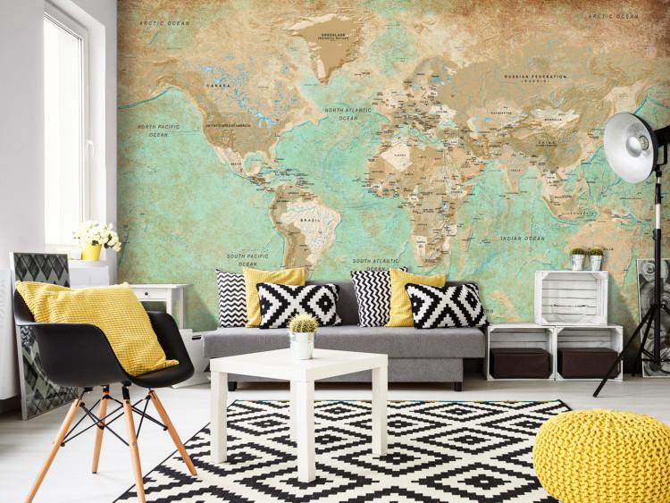 Wall Mural Turquoise world map - continents in shades of beige on a background in green