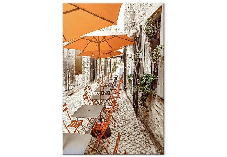 Canvas Print Italian Cafe - a photo of a narrow streets with tables and umbrellas 135841
