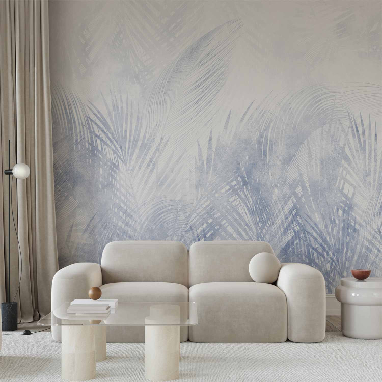 Wall Mural Interpenetrating palm leaves - plant motif in a blue shade 144641