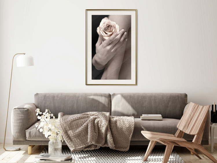 Wall Poster Subtle Fragrance - woman's hand holding rose flower on black background 128081 additionalImage 22
