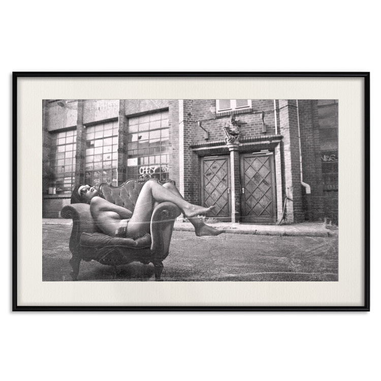 Wall Poster Casual Pose - black and white landscape of a woman in a chair with a building in the background 134181 additionalImage 19