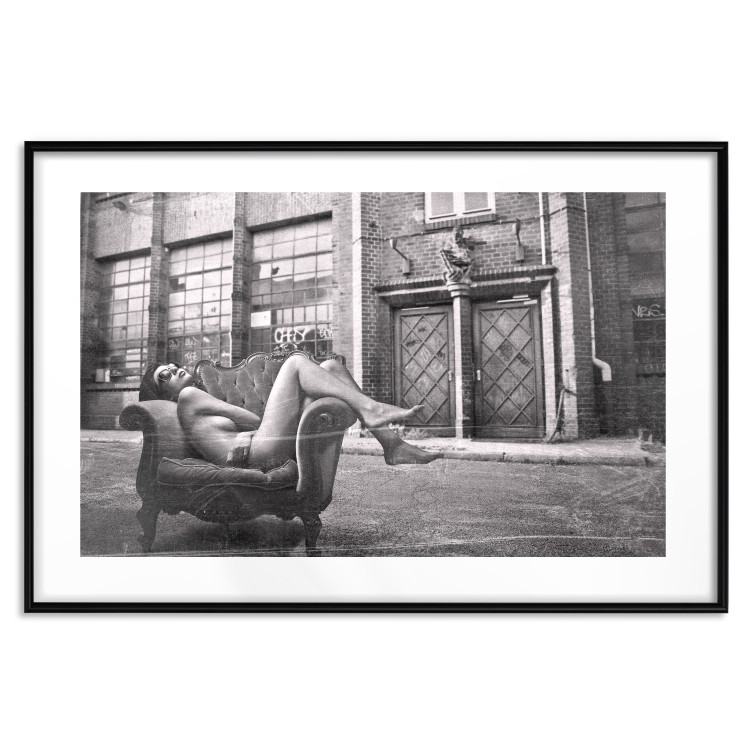 Wall Poster Casual Pose - black and white landscape of a woman in a chair with a building in the background 134181 additionalImage 17