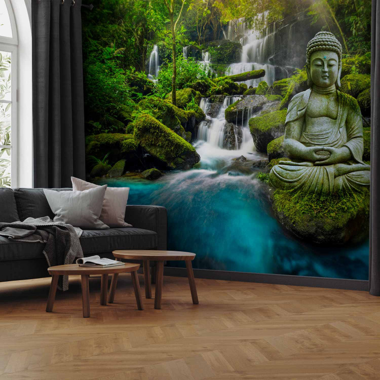 Photo Wallpaper Orient - sculpture of Buddha on the background of a waterfall in highly saturated colours 90012