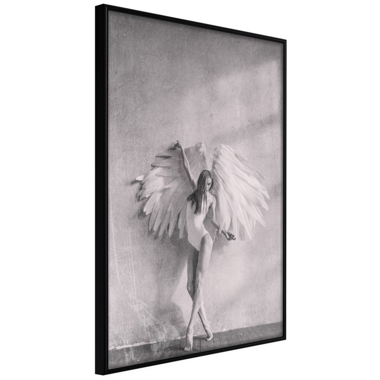 Wall Poster Winged - black and white woman with large wings against a concrete background 134182 additionalImage 13