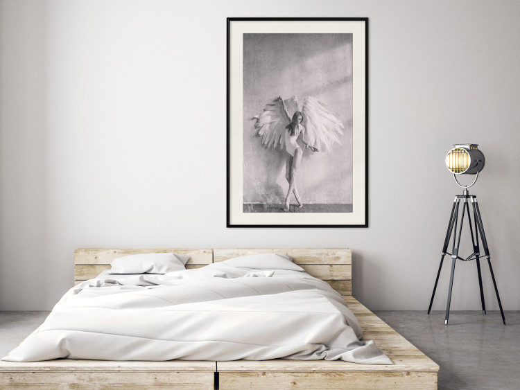 Wall Poster Winged - black and white woman with large wings against a concrete background 134182 additionalImage 25
