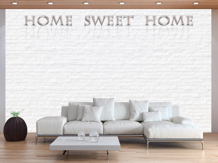 Photo Wallpaper Home Sweet Home - Beige Text with Shadow and Reflection on White Brick 60884
