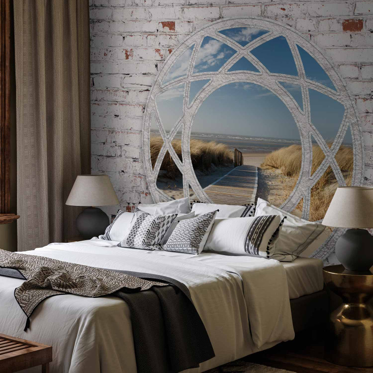 Wall Mural Window to the sea - view from a window among white bricks on a sandy beach 97325 additionalImage 2
