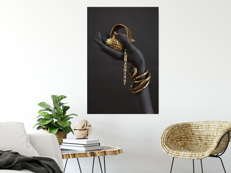 Wall Poster Royal Gifts - black hand with golden accessories on a dark background 130516 additionalImage 2