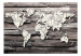 Wall Mural Passing time of the Earth - map of the world with a clock motif on grey wood 63866 additionalThumb 1