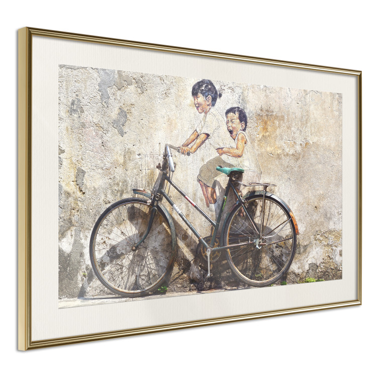 Wall Poster Carefree - retro black bicycle against a wall painted with children 130457 additionalImage 7