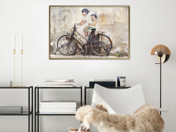 Wall Poster Carefree - retro black bicycle against a wall painted with children 130457 additionalImage 8