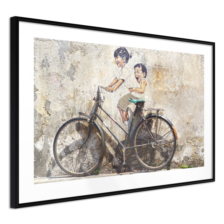 Wall Poster Carefree - retro black bicycle against a wall painted with children 130457 additionalImage 14