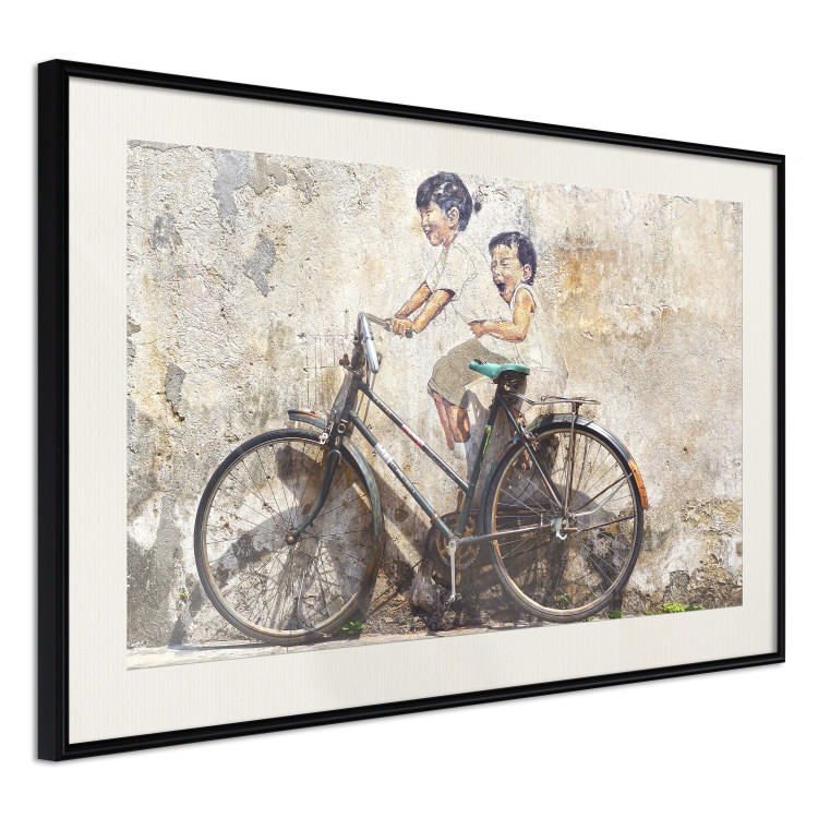 Wall Poster Carefree - retro black bicycle against a wall painted with children 130457 additionalImage 5