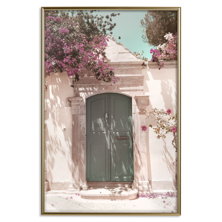Poster Charming Alley - architecture of a wall with a green entrance in the sunlight 135757 additionalImage 16