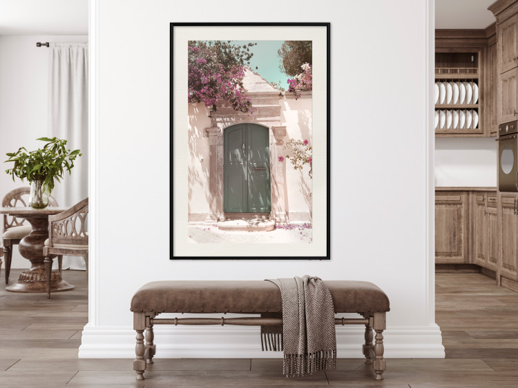 Poster Charming Alley - architecture of a wall with a green entrance in the sunlight 135757 additionalImage 21