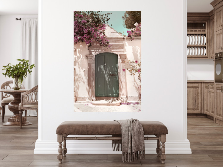 Poster Charming Alley - architecture of a wall with a green entrance in the sunlight 135757 additionalImage 14