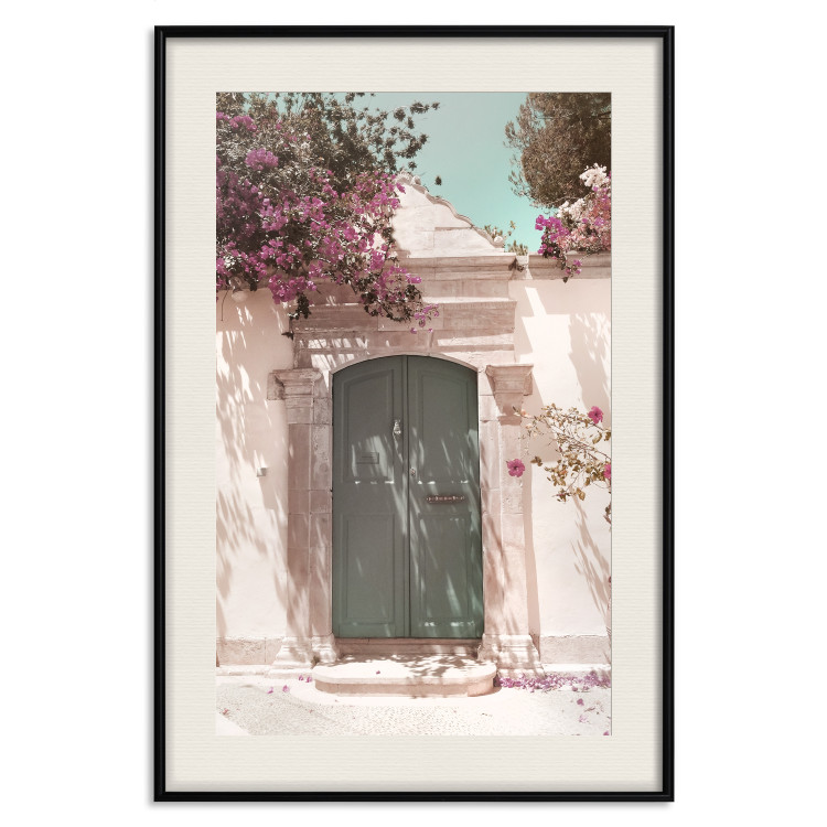 Poster Charming Alley - architecture of a wall with a green entrance in the sunlight 135757 additionalImage 26