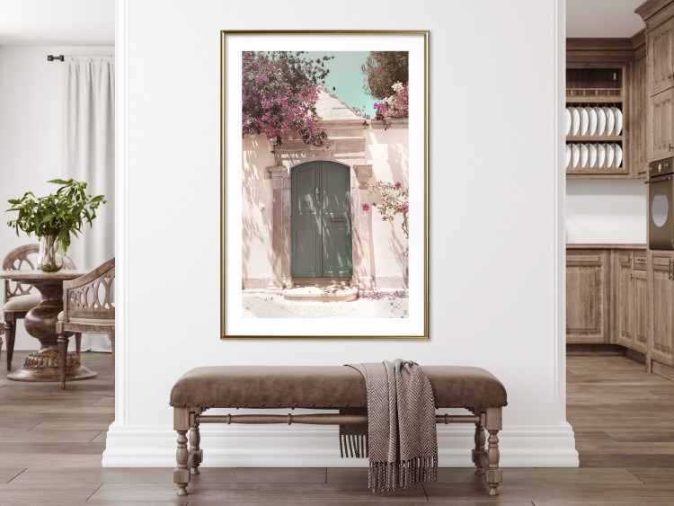 Poster Charming Alley - architecture of a wall with a green entrance in the sunlight 135757 additionalImage 11