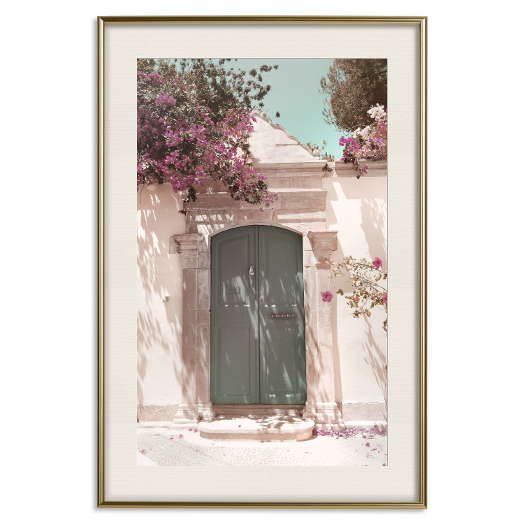 Poster Charming Alley - architecture of a wall with a green entrance in the sunlight 135757 additionalImage 27