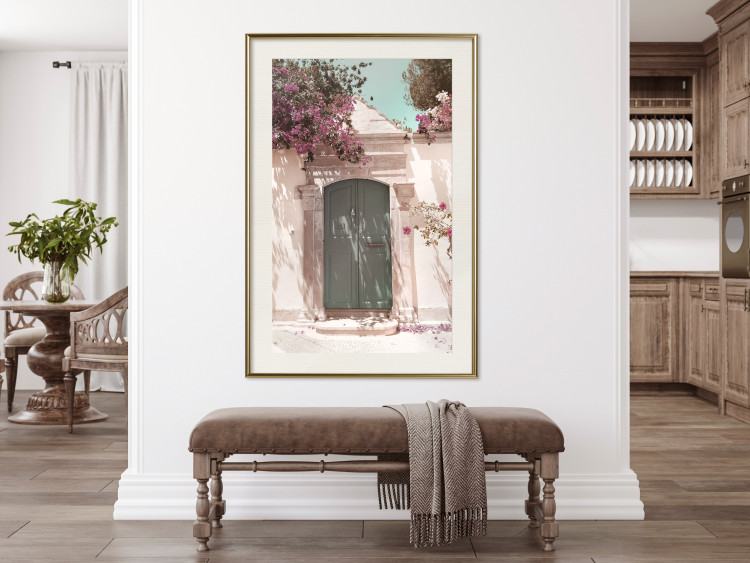 Poster Charming Alley - architecture of a wall with a green entrance in the sunlight 135757 additionalImage 22