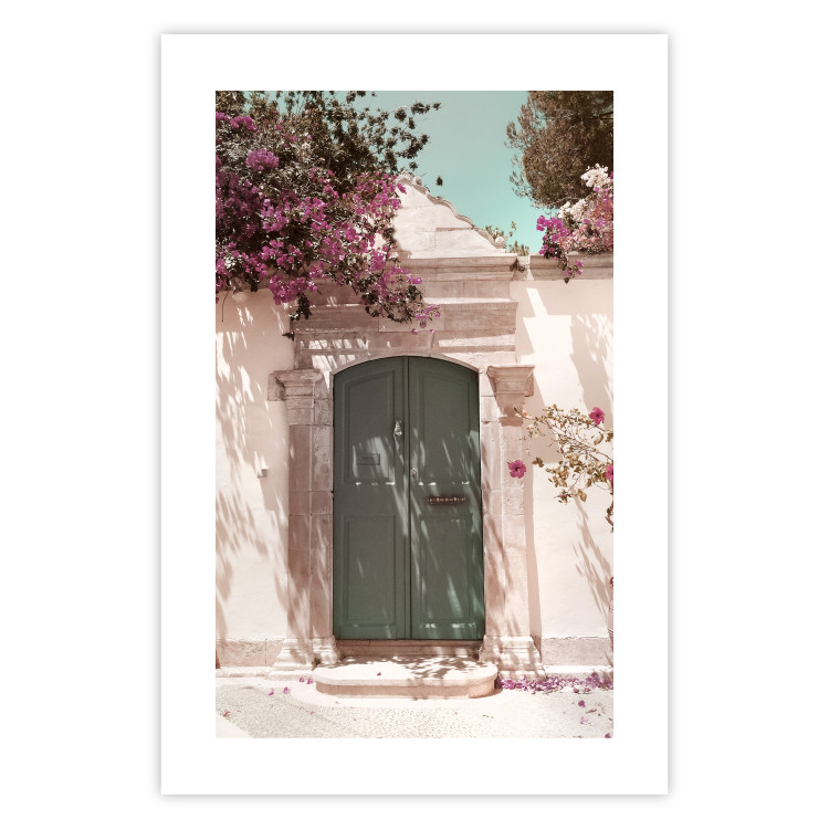 Poster Charming Alley - architecture of a wall with a green entrance in the sunlight 135757 additionalImage 23
