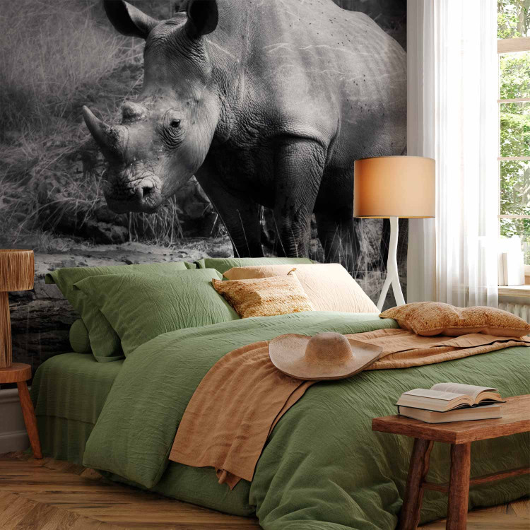 Wall Mural Peace of Animals - Black and white motif of a solitary rhinoceros on the savannah 61339 additionalImage 2